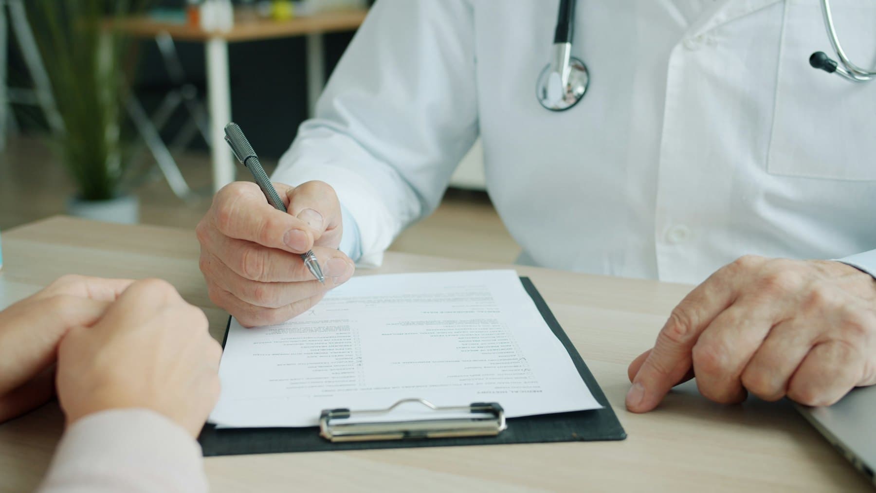 Physician documenting on a patient chart